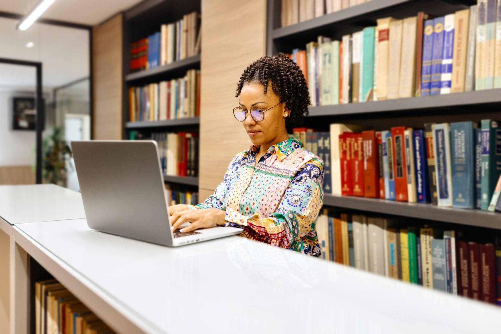 Educator with books and laptop